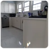 Large-format white tile kitchen floor installed by Blue Eagle Tiles